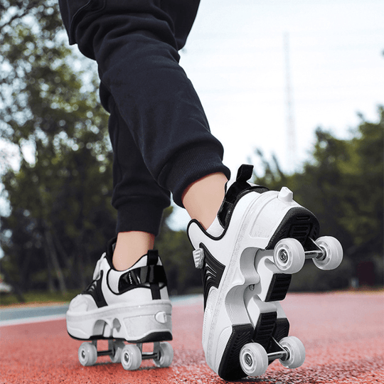 outdoor back view photo of Kick Speed Pro-X LOW Roller Skate Shoes in black and white gliding on red track surface showing pop out wheels
