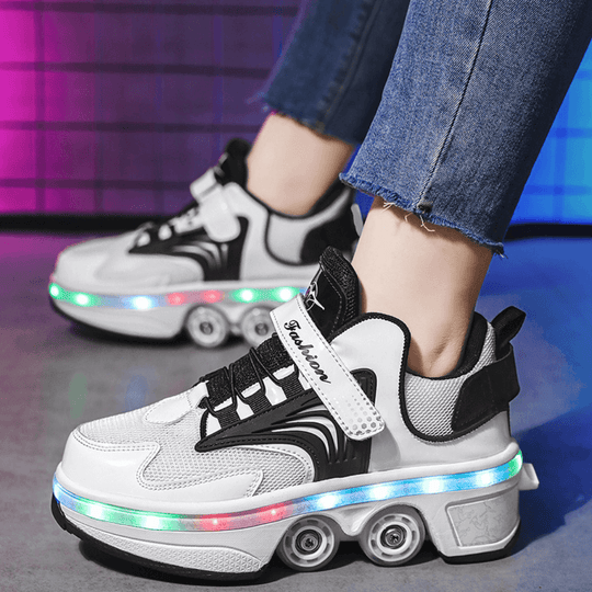 White and black roller shoes with LED lights worn by a person on a reflective surface.