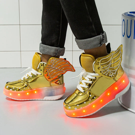 Gold roller sneakers with wing designs and LED lighting on a white floor