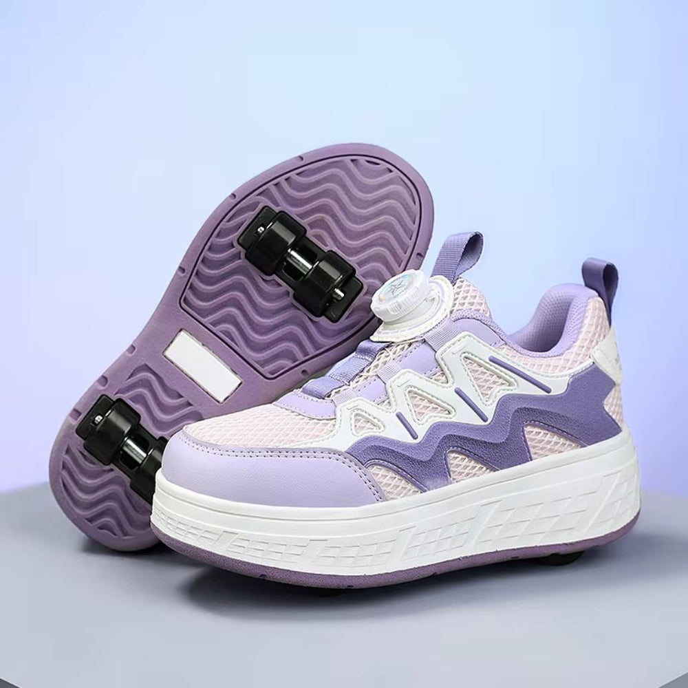 A pair of children's roller skate sneakers in lavender purple, featuring a mesh upper, wavy synthetic overlays, a dial closure, and black wheels on a light gray surface against a soft purple background