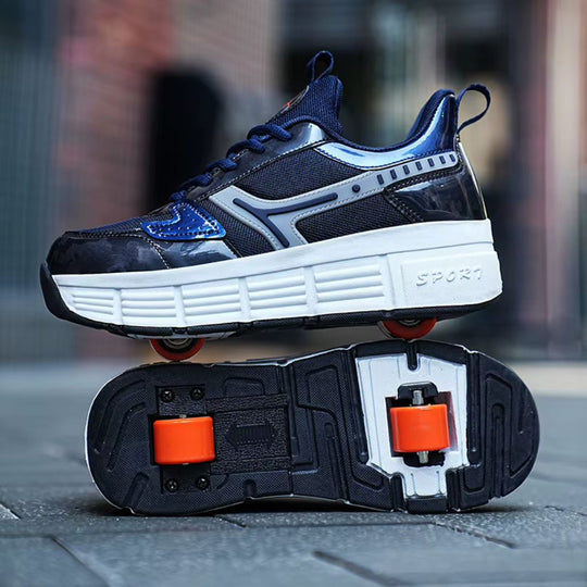 A pair of dark navy and blue roller skate shoes with a chunky white midsole and bright orange wheels, shown with one shoe standing and the other turned over to display the wheels and tread.