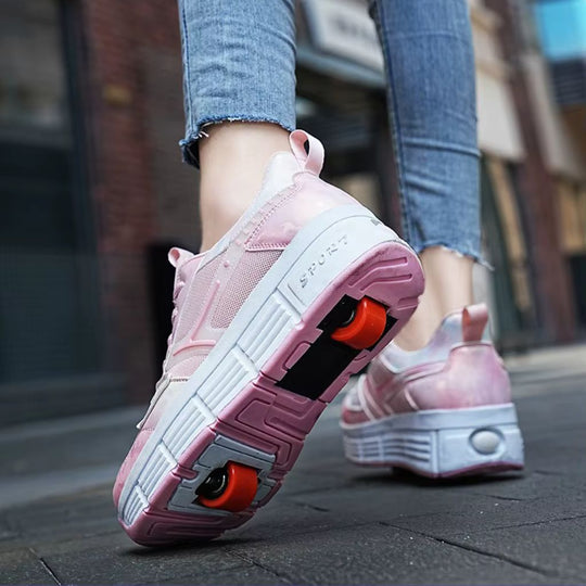 A woman wearing pink roller skate shoes with bright orange wheels, shown in a city street setting