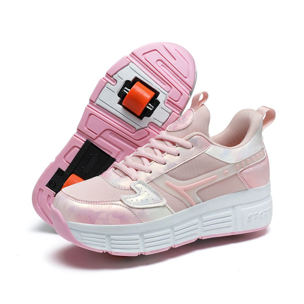 A pair of pink roller skate sneakers with a thick white sole and detachable wheel details, shown on a clean white background