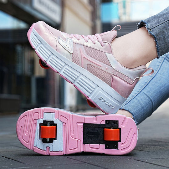 A pair of pink roller skate shoes with white and gray soles and wheel pads, shown on a person's feet with jeans in an outdoor urban setting
