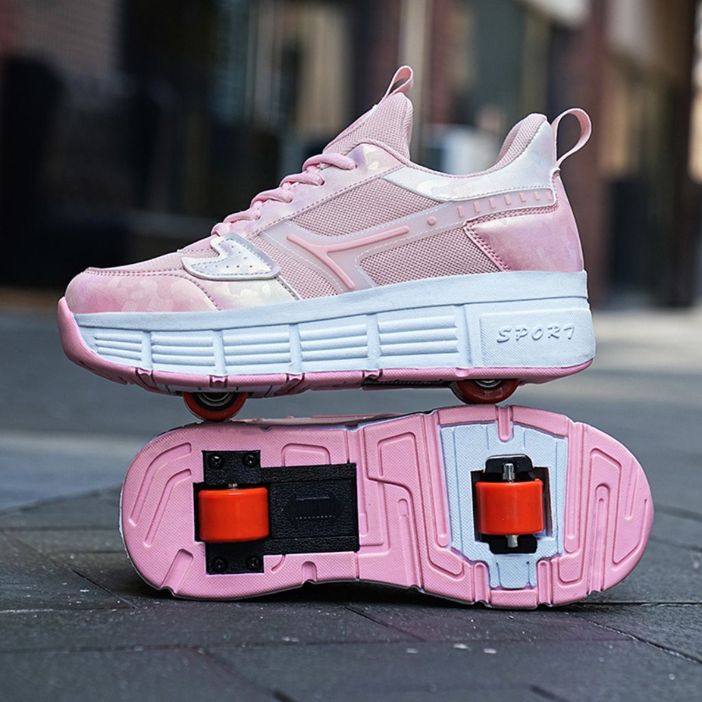 A pink shoes with built-in roller wheels, shown with the other shoe flipped over to display the underside and wheels, set against a blurred outdoor street background