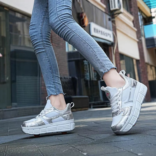 A person wearing chunky platform heel wheel roller shoes with metallic silver and white panels, walking on a paved street in an urban setting