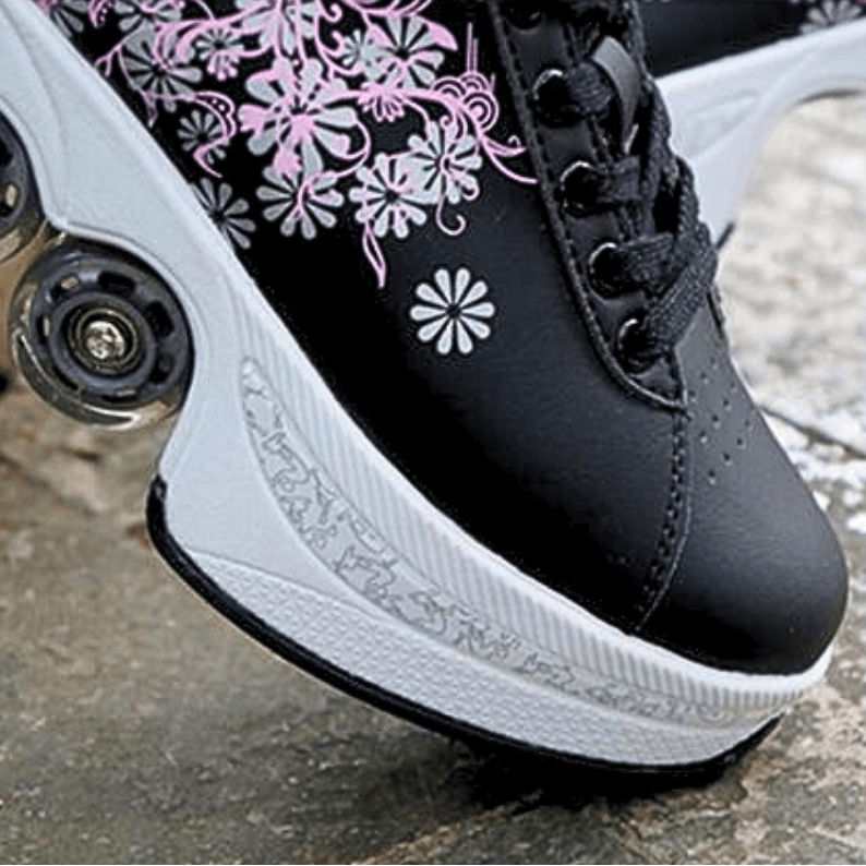 outdoor close up photo of black Kick Speed roller skate shoes with floral pattern and retractable wheels