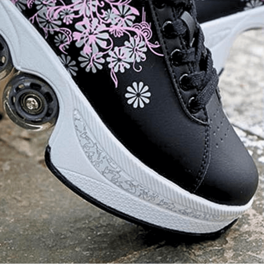 outdoor close up photo of black Kick Speed roller skate shoes with floral pattern and retractable wheels