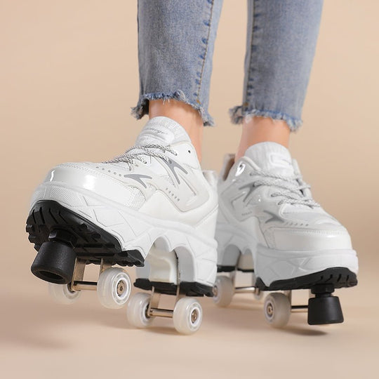 front view of white roller skate shoes with wheels and toe stops for beginners photographed on beige background during motion