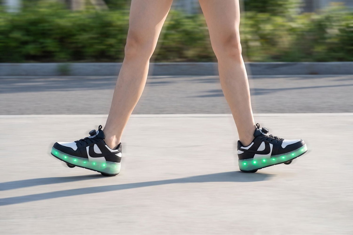 Black and white Kick Speed LED roller shoes rolling outdoors with front and rear wheels fitted