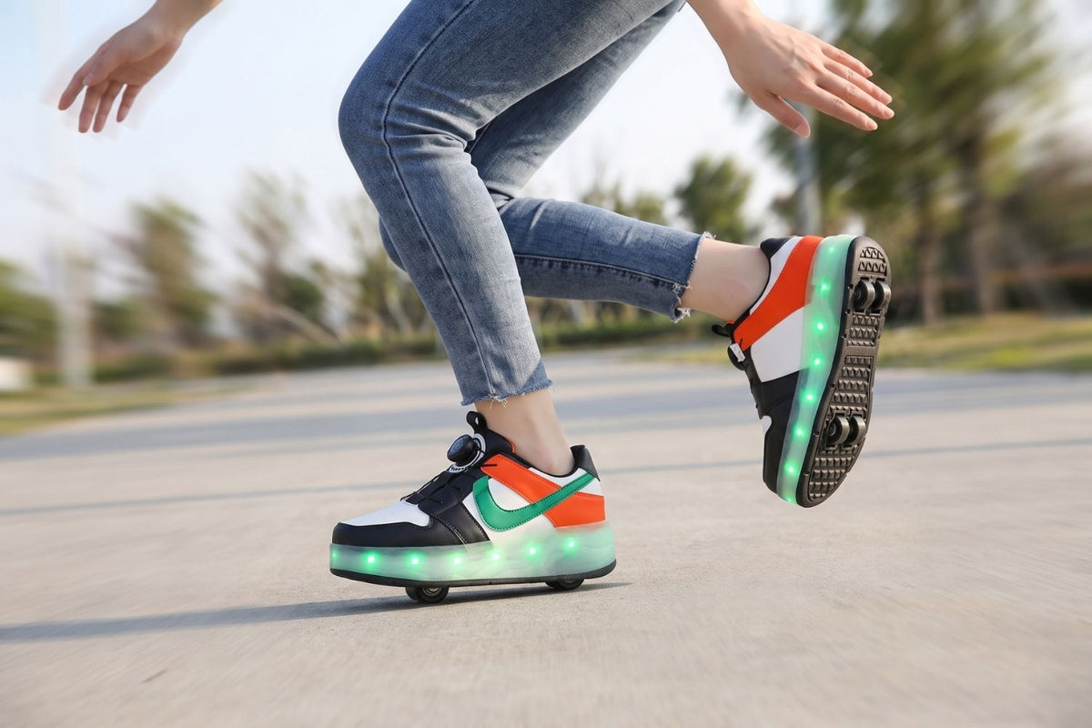 Green and orange Kick Speed LED roller shoes rolling on one foot, the lifted shoe showing both wheel positions in the sole