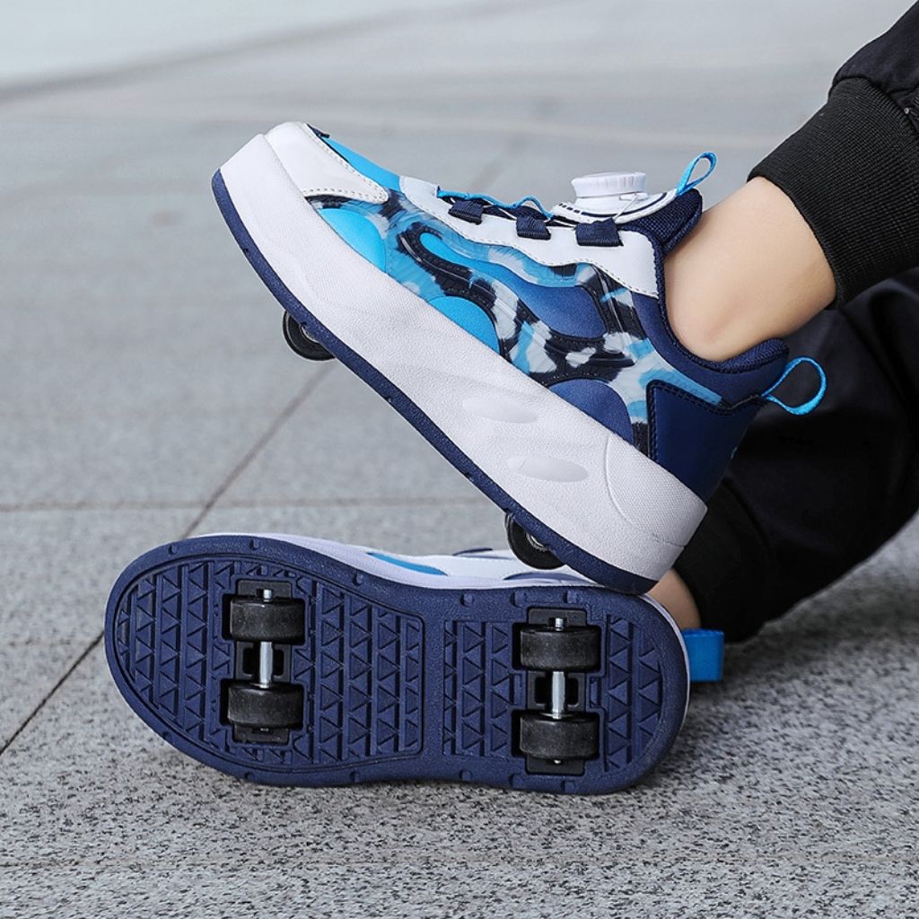 Blue roller shoes with black wheels on a gray pavement background