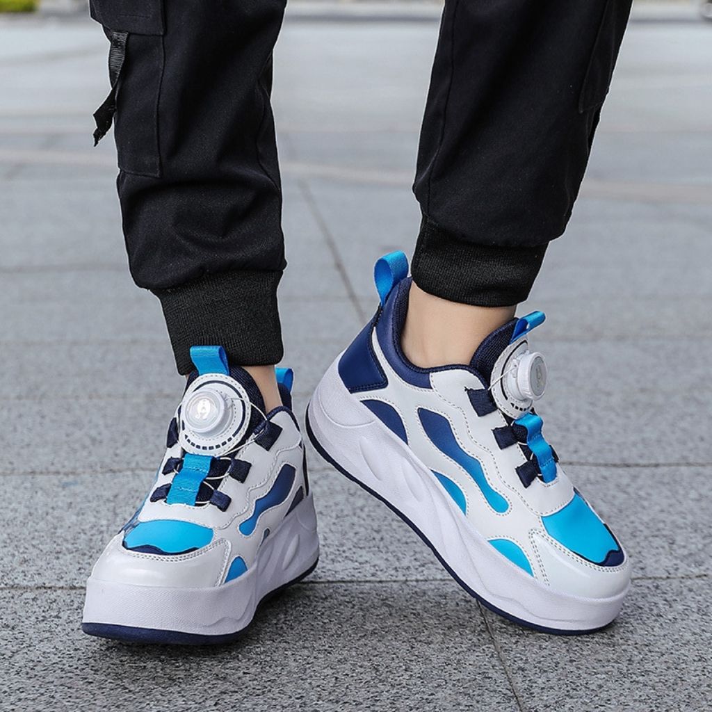 Blue shoe with wheels with a dial-up lace closure, shown on a person wearing black cargo pants
