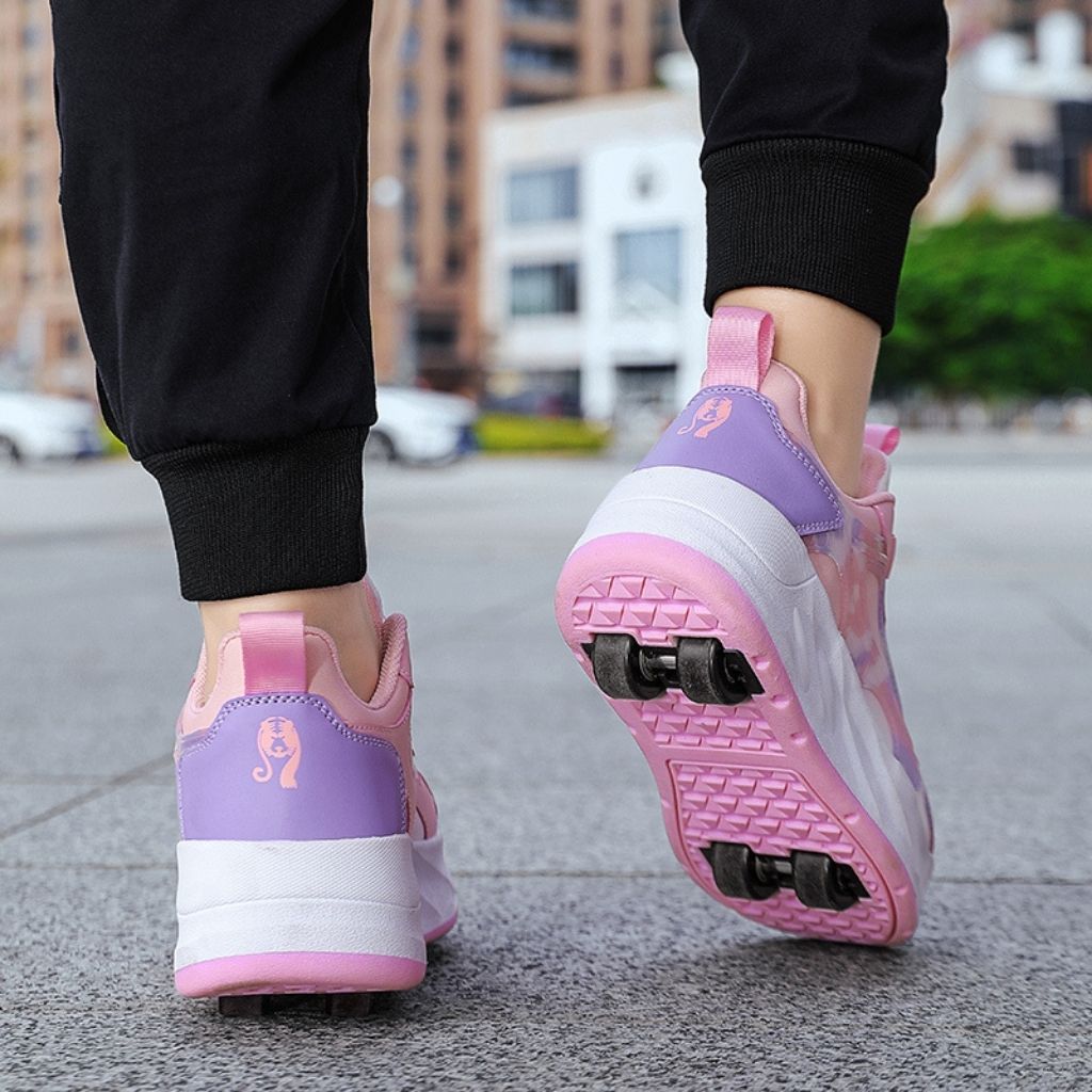 A person wearing pink roller skate shoes with black pants, shown from the back in an outdoor urban setting