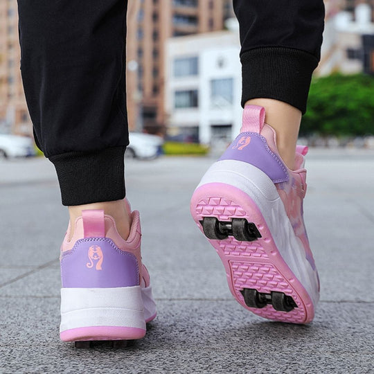 A person wearing pink roller skate shoes with black pants, shown from the back in an outdoor urban setting