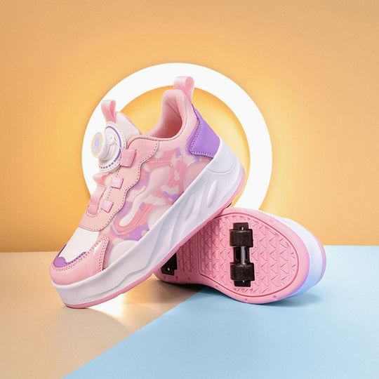 A pair of children's heel wheel shoes in pink, featuring a dial-up closure and visible black wheels on the soles, set against a split beige and light blue background with a white circular light