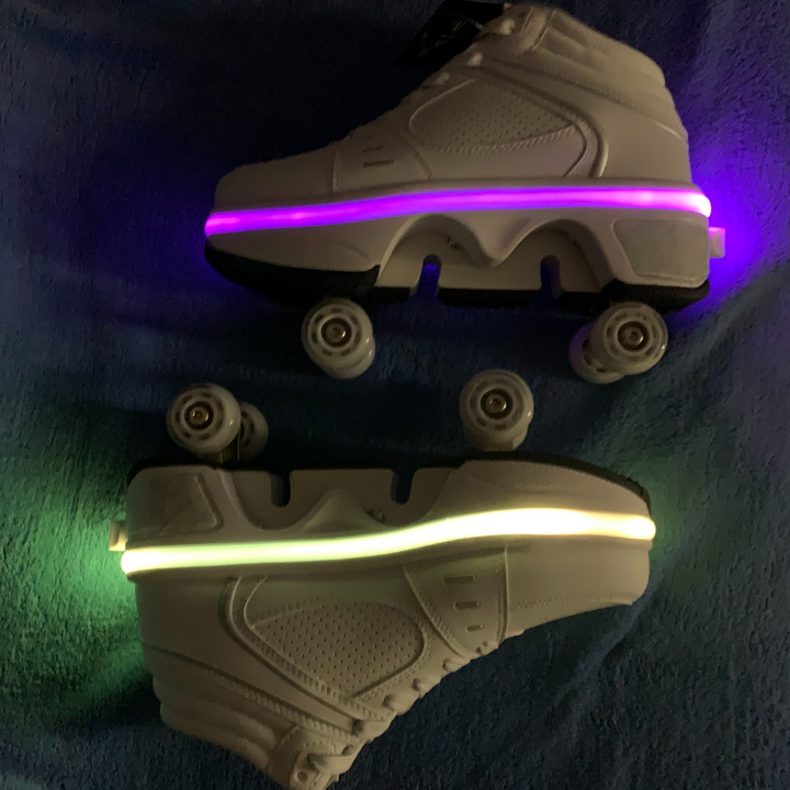 Kick Speed LED roller shoes with pop out wheels glowing purple and yellow in low light