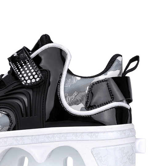 side close-up of black roller skate shoes showing structure and velcro closure