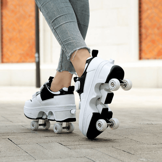 back view of black and white low-top roller skate shoes in use outdoors, showing full wheel setup and grip sole