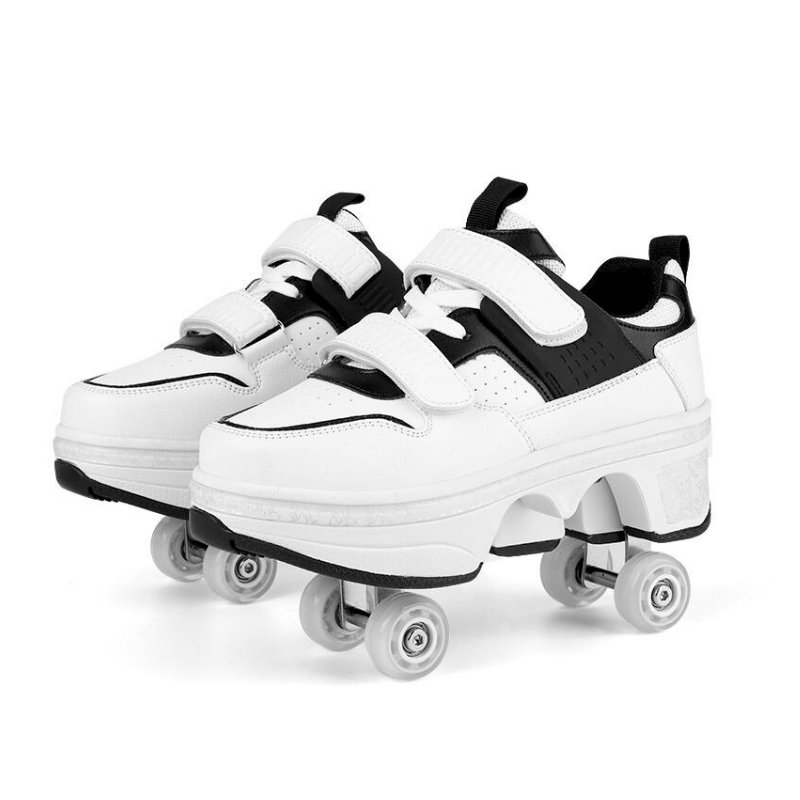 white quad skate shoes with black details for kids with pop-up wheels displayed on plain backdrop