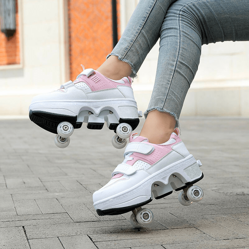 outdoor shot of white and pink roller shoes for kids showing functional wheel base on sidewalk