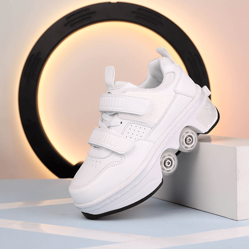 side view of white low-top roller skate shoes with pop-up wheels positioned on modern display