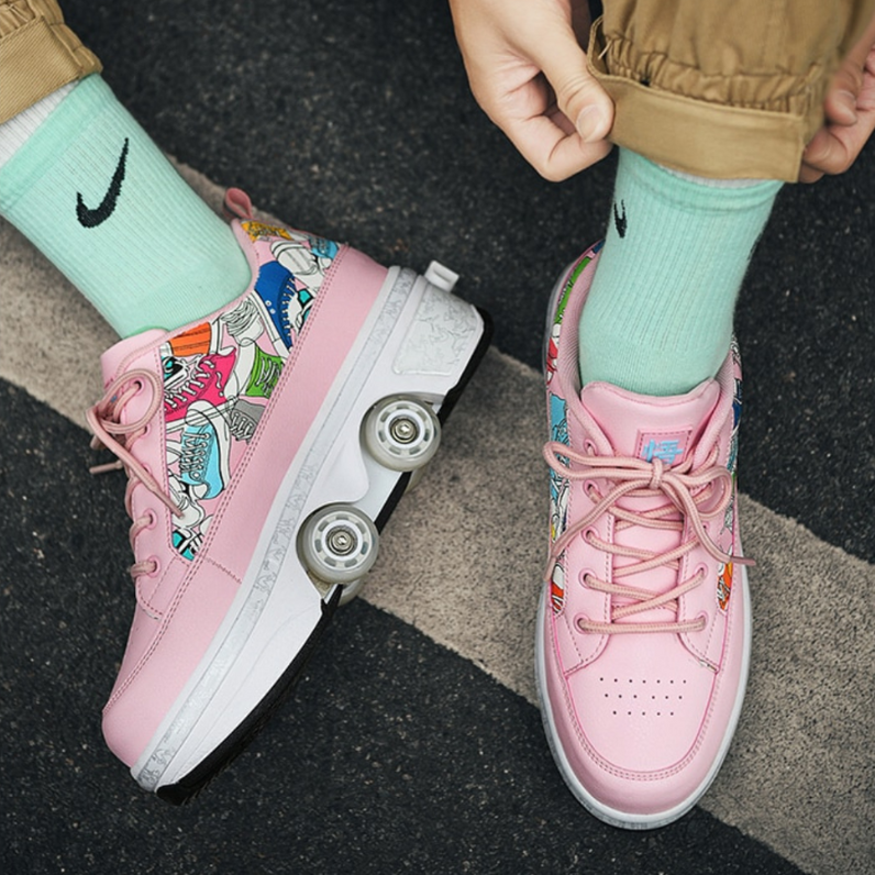 pink Kick Speed roller shoes with wheels, top view on pavement showing laces and wheels