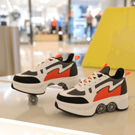 Pair of orange Speed Volt LOW roller shoes with wheels displayed indoors, sneakers with wheels for adults and teens